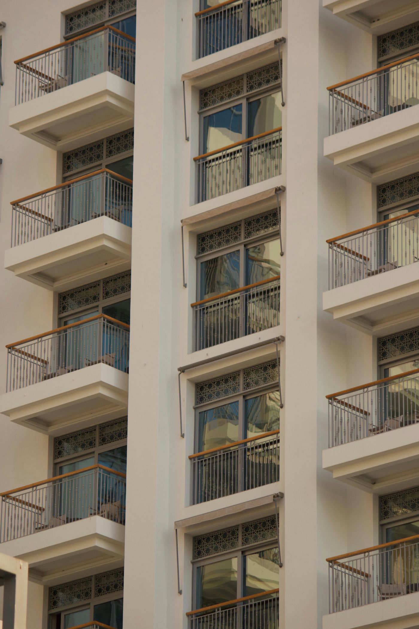 Sunlight across real apartment balconies and windows